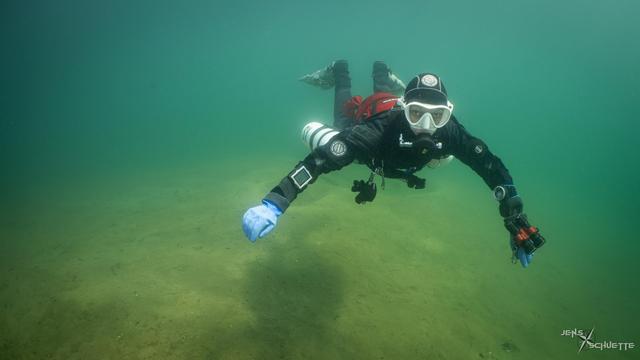 Shadow diver...Konni underwater in a lake in sunny weather conditions
