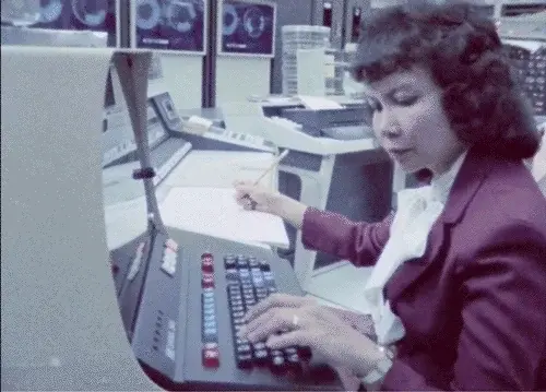Woman working on a computer from the 60ties or 70ties